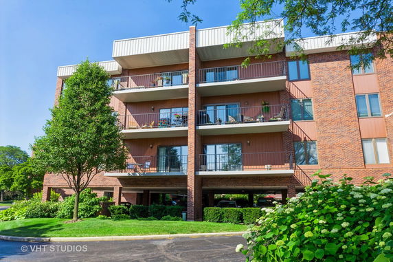 Front view of a multi-story residential building with balconies.