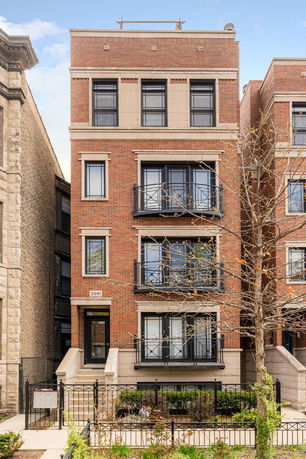 Front view of a multi-story brick apartment building.