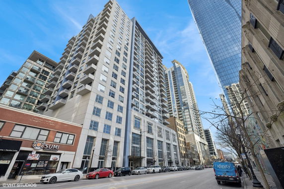 Front view of a multi-story residential building with balconies.