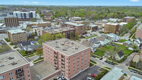 Panoramic view of a neighborhood with multiple apartment buildings and houses.