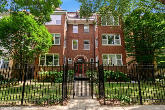 Front view of a three-story brick building with multiple windows and a central entrance.