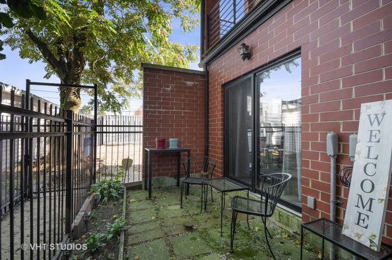 Front view of a modern brick building with a small patio area.