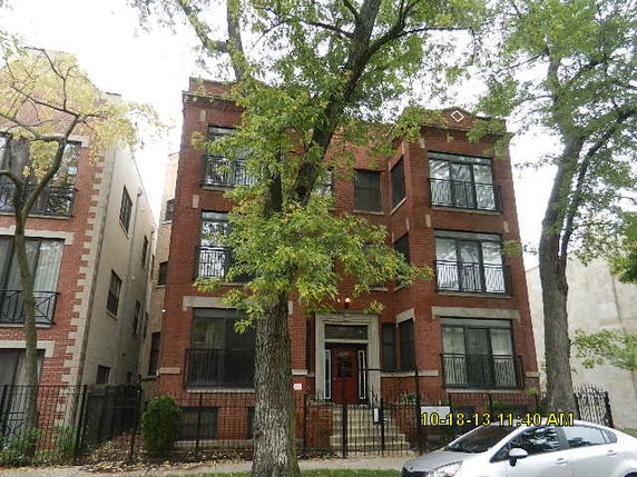 Front view of a three-story brick apartment building.
