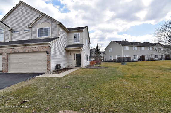 Front view of a two-story house with an attached garage.
