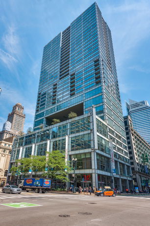 Front view of a tall modern skyscraper with glass facade.
