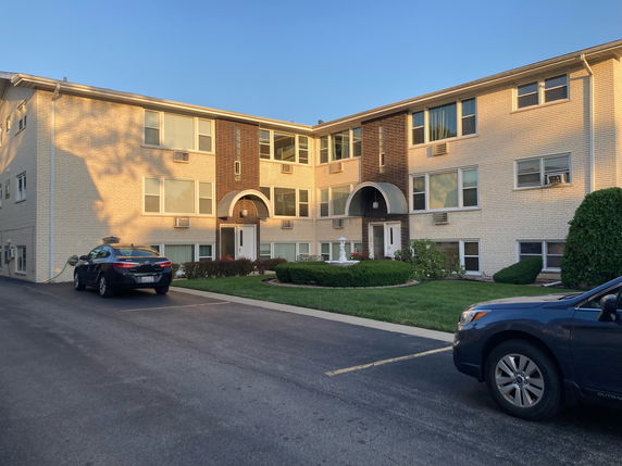 Front view of a two-story apartment building with a central entrance.