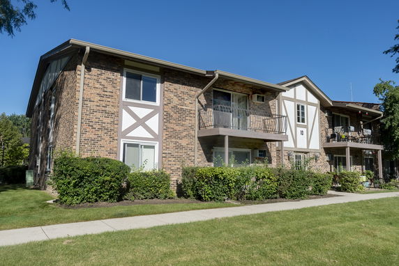 Front view of a two-story apartment building with balconies.