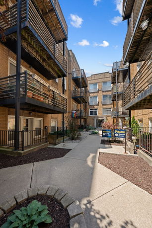 Exterior view of an apartment building with multiple balconies.