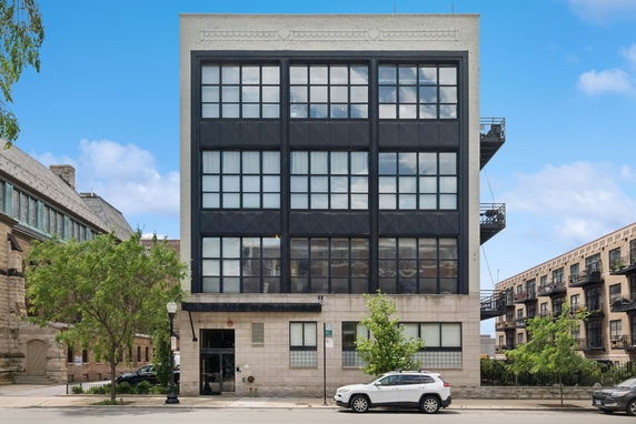 Front view of a multi-story building with large windows