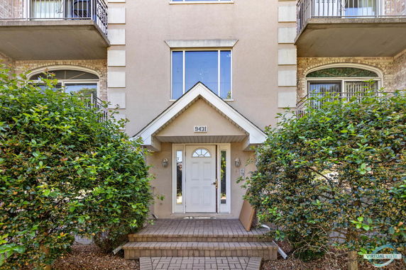 Front view of a house entrance with a central white door and overhang.
