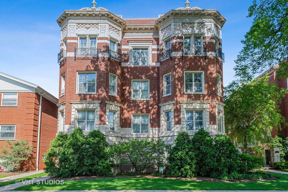 Front view of a multi-story brick building with decorative architectural details.