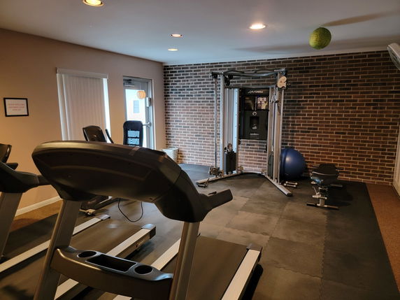 Indoor gym area with treadmills and exercise equipment.