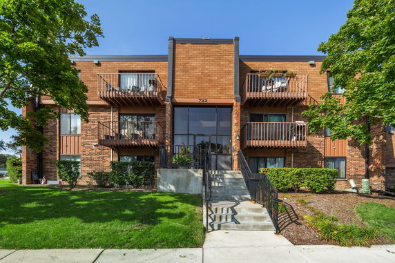 Front view of a two-story apartment building with balconies.