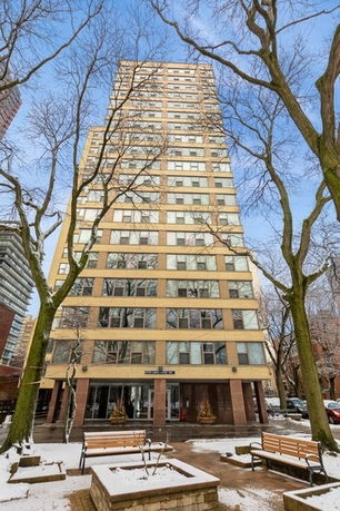 Front view of a high-rise building with multiple floors and a central entrance.
