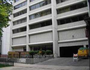 Front view of a multi-story building with a ramp and entrance.
