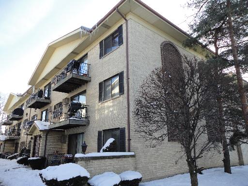 Front view of a multi-story residential building with balconies.