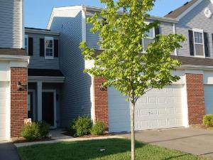 Front view of a residential townhouse with a double garage.