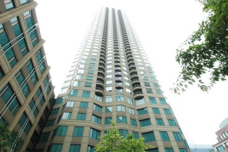 View looking up at a tall residential or office building.