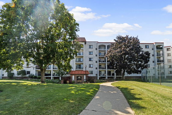 Front view of a multi-story residential building with balconies.