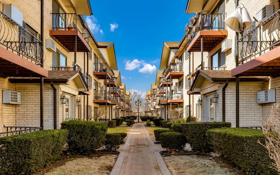 Front view of multiple three-story residential buildings with balconies