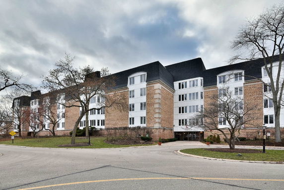 Front view of a multi-story brick building with numerous windows.