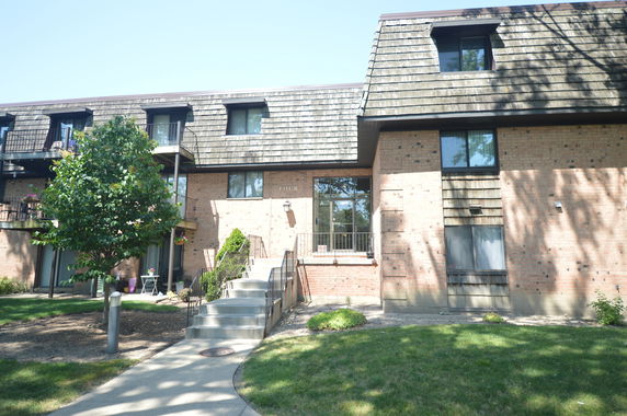 Front view of a multi-story brick building with balconies.