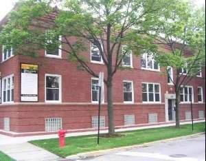 Front view of a two-story brick building with multiple windows.
