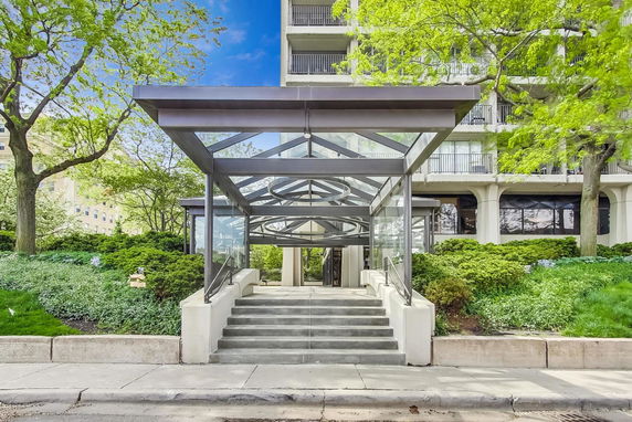 Front view of a multi-story building with a modern entrance canopy.