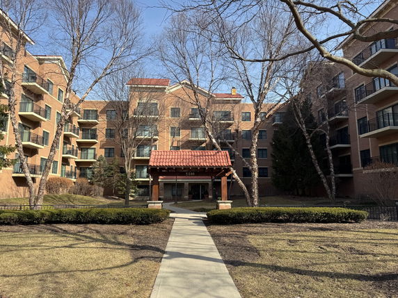 Front view of a multi-story apartment building with balconies.
