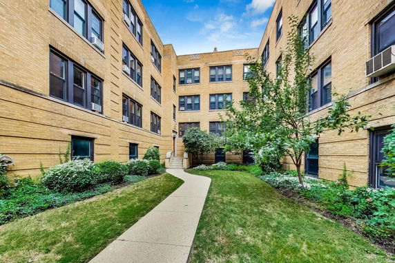 Front view of a multi-story brick apartment building.