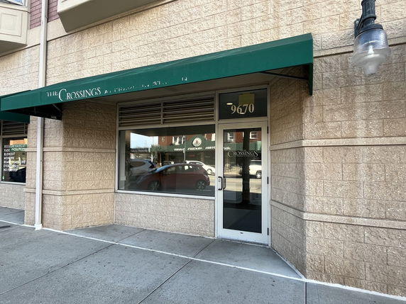 Front view of a commercial building with an awning.