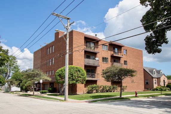 Front view of a multi-story brick apartment building.