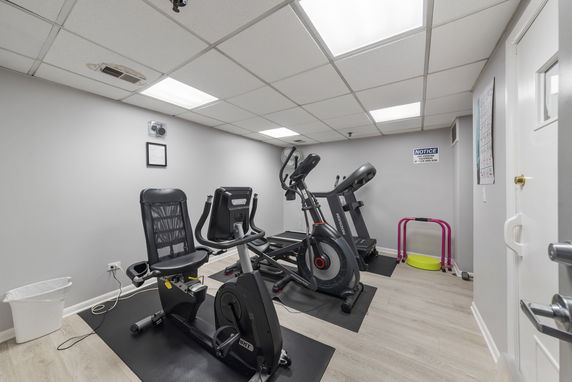 Indoor gym area with exercise equipment.