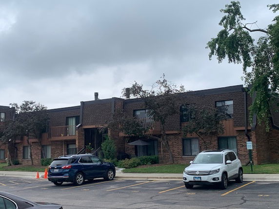 Front view of a two-story apartment building with balconies.