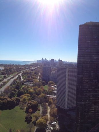 Panoramic view of a cityscape with tall buildings and a distant skyline.