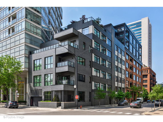 Front view of a modern multi-story building in an urban setting.