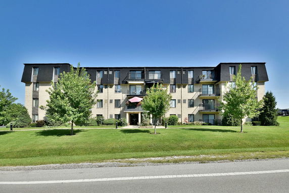 Front view of a multi-story residential building with balconies.