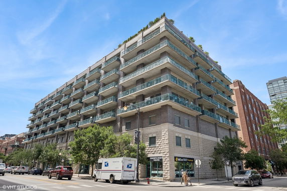 Front view of a multi-story building with balconies and a modern design.