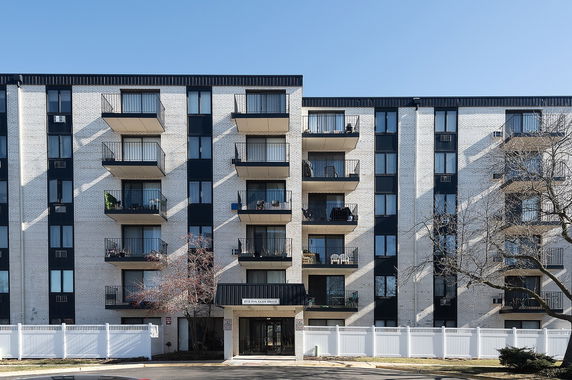 Front view of a multi-story apartment building with balconies
