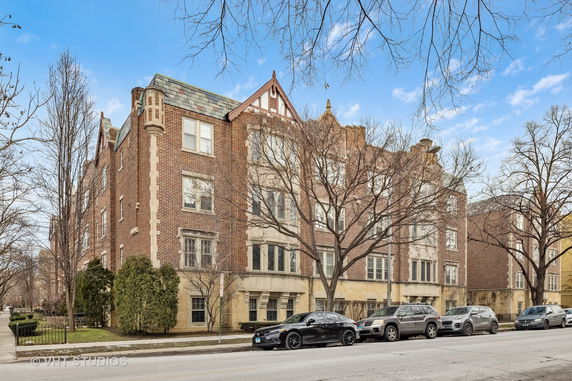 Front view of a multi-story brick building with decorative architectural elements.