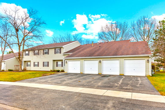 Front view of a two-story house with a three-car garage.