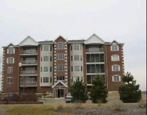 Front view of a multi-story brick building with balconies.