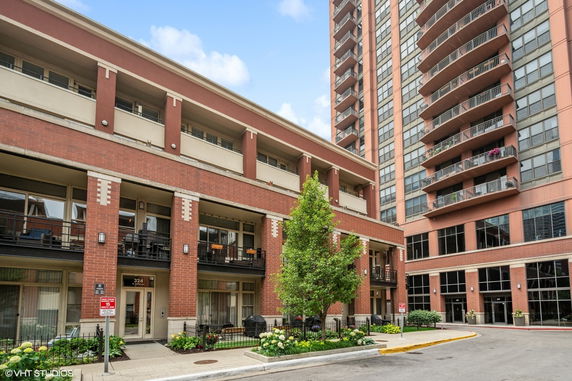 Front view of a multi-story residential building with balconies.