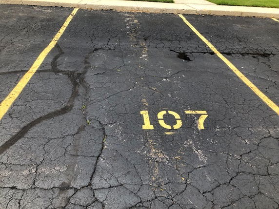 Image of an outdoor parking space marked with number 107.