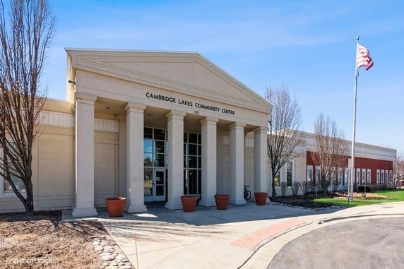 Front view of a community center with columns and large entrance.