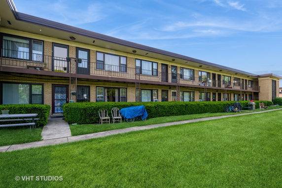 Front view of a two-story apartment building with balconies.