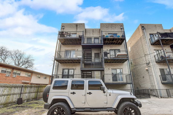 Rear view of a multi-story apartment building with balconies.