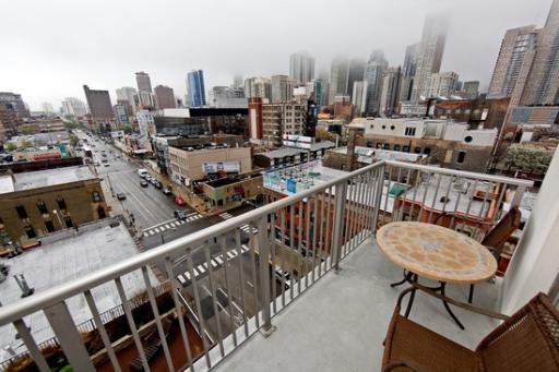 Panoramic view from a building balcony overlooking a cityscape.