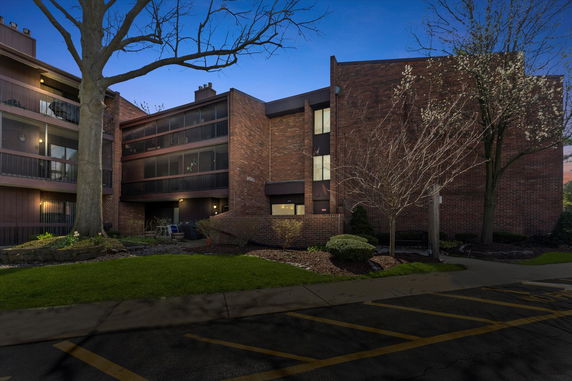 Front view of a multi-story brick building with balconies.