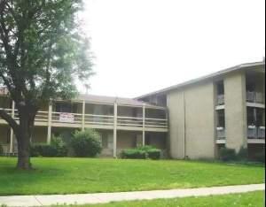 Front view of a multi-story building with balconies.